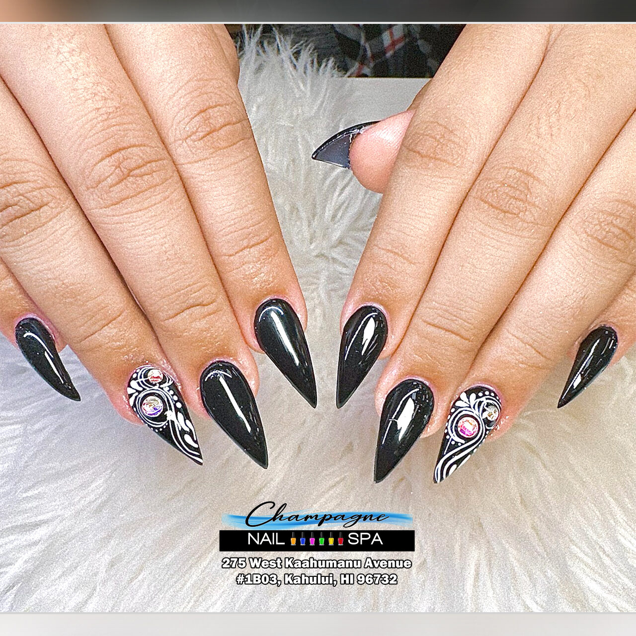 Black stiletto nails with baroque art at Gold Nails Maui, Kahului